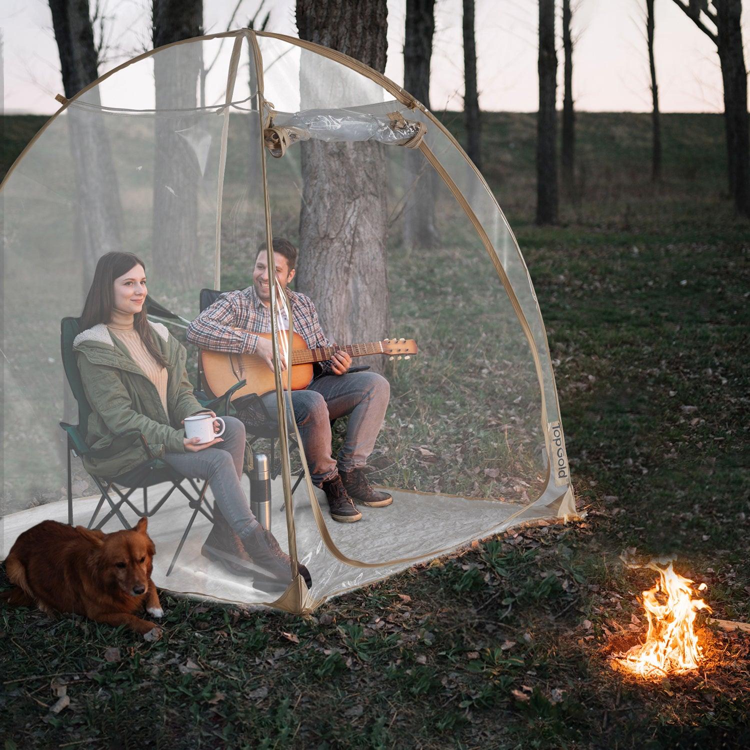 TopGold pop up weather pod in the forest around a campfire